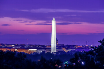 Wall Mural - Washington Monument at sunrise with orange and purple clouds in the background Washington DC, USA