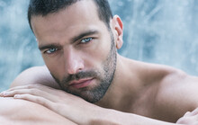 Sexy Closeup Portrait Of Handsome Topless Male Model With Beautiful Eyes Staring Deep At The Camera. 