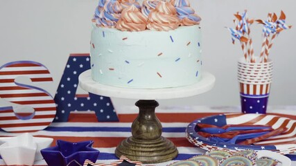 Wall Mural - Red, white, and blue cake and pinwheel cookies at the July 4th celebration party.