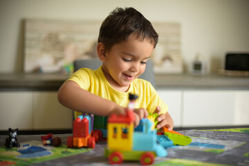 young boy playing home with blocks