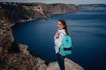 Woman above cold sea on cliff alone. Travel Lifestyle concept