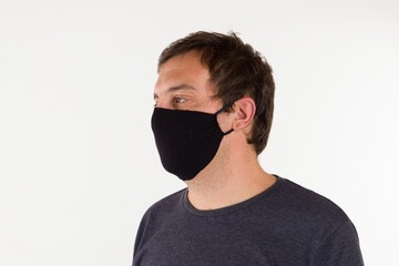 Sticker - Portrait of a Hispanic male wearing a black medical face mask to prevent the spread of Covid-19