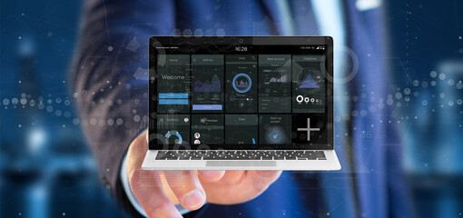 Wall Mural - businessman holding laptop with business user interface data on the screen isolated on a background