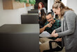 © JonoErasmus - Two smiling businesspeople discussing paperwork in a coworking office space