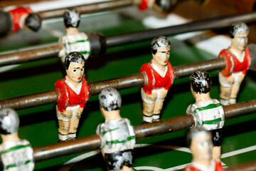 Closeup on miniature metallic ball players of a Foosball table soccer game