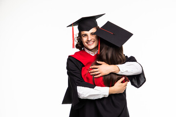 Wall Mural - Happy graduated young students couple hugging isolated on white background