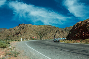 the car is driving on an asphalt road