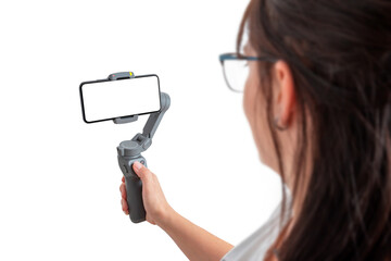 Wall Mural - Woman holding gimbal with smart phone. Isolated background and display for mockup.