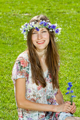 Wall Mural - young woman lying on the grass over green natural background