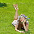 young woman lying on the grass over green natural background