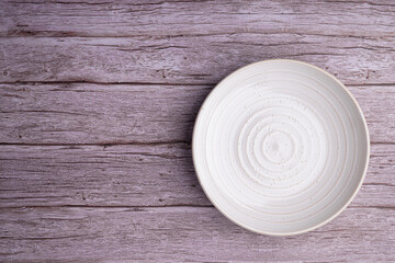 Wall Mural - Top view of a plate on an old wooden table. Space for text.