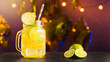 Sweet cocktail with lime in front of party background, summer drink for summer party