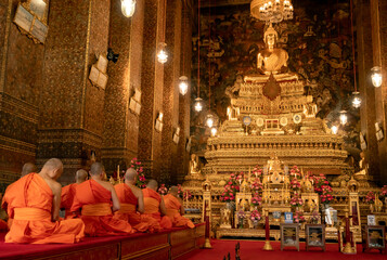 Monks meditating and praying in buddhist temple Bangkok