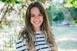 © loreanto - Portrait of a young beautiful blonde woman in the park in summer - Millennial outdoor in a moment of relax looking the camera and smiling
