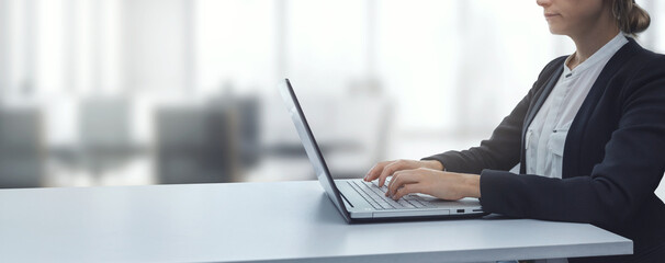 young businesswoman working on laptop in modern bright coworking office. business background copy space