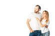 © LIGHTFIELD STUDIOS - cheerful adult couple in white t-shirts pointing with finger aside isolated on white