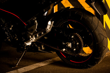 Wall Mural - Black motorcycle on the background of underground parking.