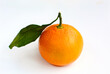Ripe juicy tangerine with leaves on a white background.