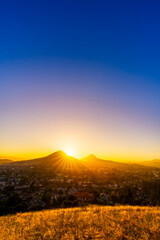 Wall Mural - Hazy Sunset in the Mountains with Starburst Sun