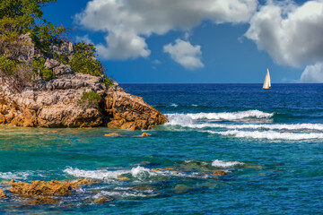 Sticker - A White Surf Hitting Rocks on an island paradise