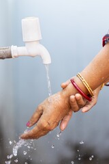 Sticker - Female washing hands under the faucet - importance of washing hands during the COVID-19 pandemic