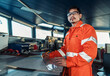 © Igor Kardasov - Filipino deck Officer on bridge of vessel or ship wearing coverall during navigaton watch at sea . He is plotting position on chart