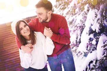 Canvas Print - Lovely couple spending time together on snowy day. Winter vacation