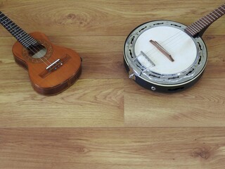 Sticker - Close-up of two Brazilian string musical instruments: cavaquinho and samba banjo on a wooden surface. They are widely used in samba and pagode ensembles, popular Brazilian rhythms. Top view.