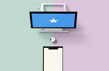 Wall Mural - Somalia national flag on computer screen top view, cupcake and empty note paper for planning. Minimal concept with turquoise and purple background.