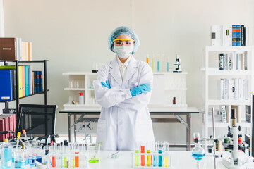 Asian scientists are preparing chemicals for testing and analysis in the laboratory. Scientists clear glasses and white shirts. Science and Chemistry Concept