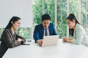 Managers and secretaries meeting and discussing business results from notebooks and paper charging statistics are in the company.