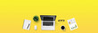 © sirisak - Top view business office desk with laptop, coffee, notebook, a report paper, and office supplies / Creative flat lay photo of workspace desk and copy space / Panoramic banner yellow background