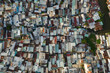 crowded old residential and business area resembling a crowded shanty town built along a canal from aerial top down view