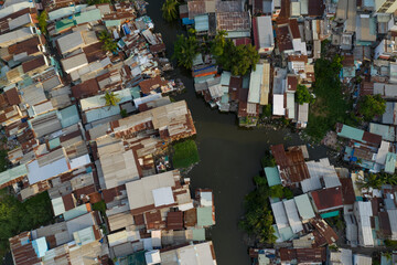 old residential and business area of Southeast Asia resembling a crowded shanty town built along a canal from aerial top down view