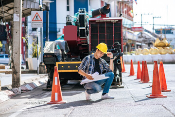 Civil engineers work on large road and machinery conditions.