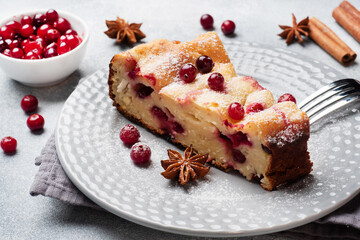 Wall Mural - Cheesecake with cranberries and cinnamon. Casserole with cottage cheese on a plate.