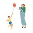 © greenpicstudio - Mother making photo of her smiling son with balloon during summer festival