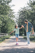 © zinkevych - Cute boy riding a skateboard, his father holding his hand