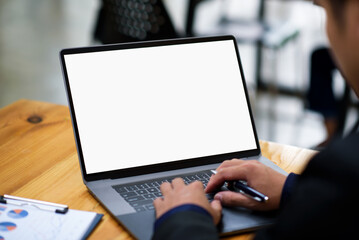 Young man working on his laptop with blank copy space screen for display advertise.
