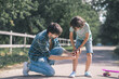 © zinkevych - Dark-haired boy touvhing his imjured knee, his gather helping him