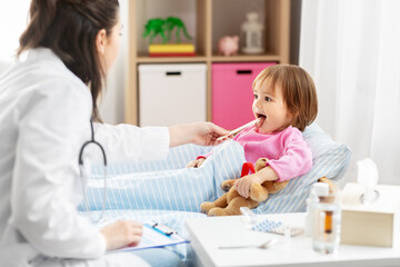 Sticker - healthcare, medicine and people concept - doctor checking sick little girl's throat with tongue depressor in bed at home