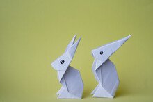 Simple Flat Lay Out. Two White Rabbits Paper Origami On Clear Background With Copy Space Concept