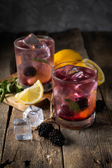 Wall Mural - Blackberry lemonade on rustic wood background, copy space