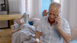 © TommyStockProject - Worried mature man calling doctor to consult about ill wife