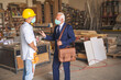 © Jelena - Two caucasian workman standing and talking, wearing face masks