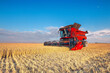 © Vladimir Kayukov - Harvesting of grain crops in the field, a bright summer landscape with a combine harvester. Selective focus.