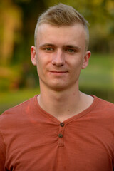 Young man with blond hair at the park outdoors