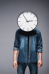 Wall Mural - Man with clock on head standing on grey background, concept of time management