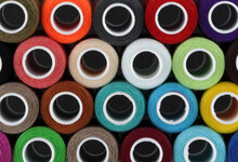 Colored Cotton Reels Background Pattern Close Up