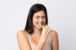 © luismolinero - Teenager Brazilian girl brushing her teeth over isolated white background